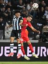 Taison, într-un duel aerian cu Lixandru la PAOK - FCSB 0-1 Foto: Imago